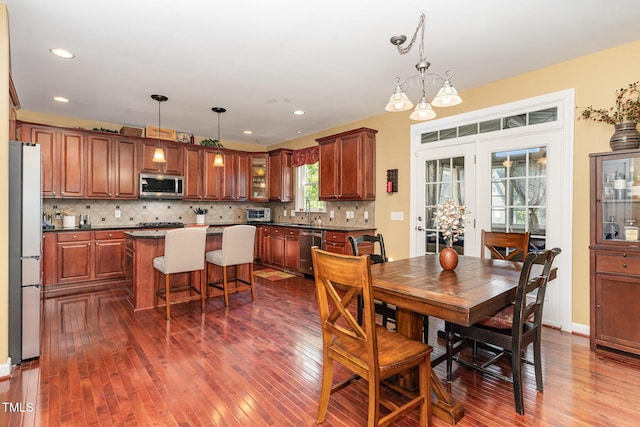 dining room with dark wood-style floors and recessed lighting