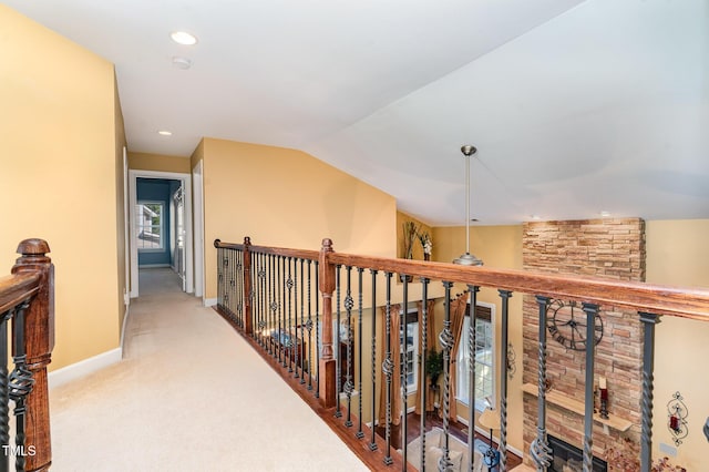 corridor featuring baseboards, lofted ceiling, carpet flooring, recessed lighting, and an upstairs landing