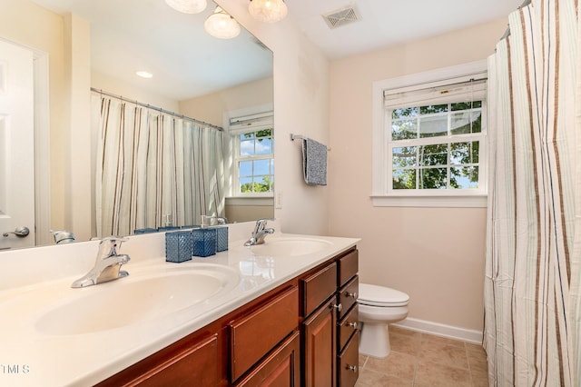 full bathroom with toilet, baseboards, double vanity, and tile patterned flooring