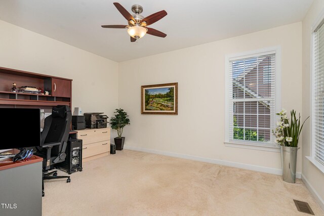 office space with carpet flooring, a ceiling fan, and baseboards