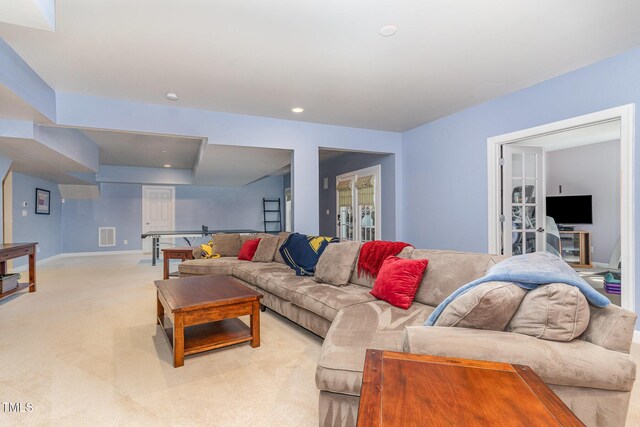 living area featuring light colored carpet, recessed lighting, and baseboards