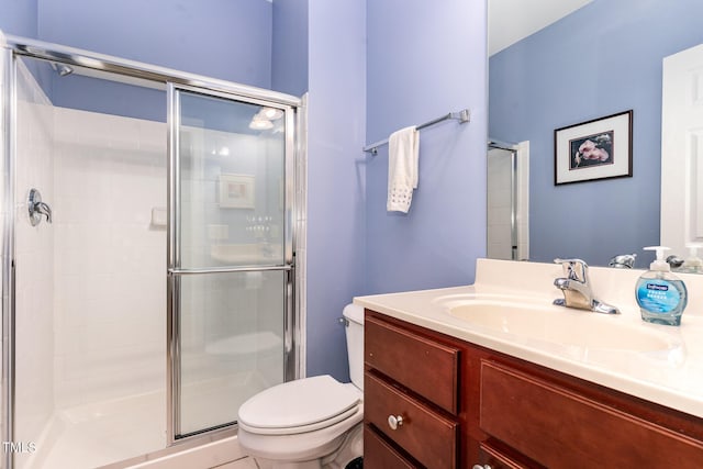full bathroom with a shower stall, toilet, and vanity