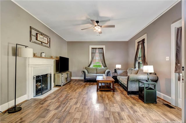 201 W 16th St, Lumberton, NC 28358 - living area with ornamental molding, a ceiling fan, wood finished floors, baseboards, and a fireplace