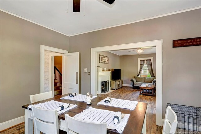 201 W 16th St, Lumberton, NC 28358 - dining space with ceiling fan, crown molding, wood finished floors, baseboards, and stairs