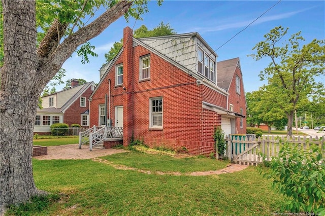 201 W 16th St, Lumberton, NC 28358 - rear view of house with an attached garage, brick siding, and a chimney