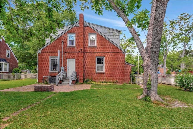 201 W 16th St, Lumberton, NC 28358 - back of house with a chimney, brick siding, a patio area, entry steps, and central AC