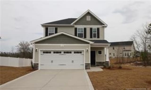 craftsman inspired home with concrete driveway and an attached garage