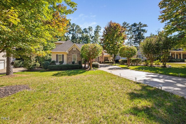 39 Forked Pine Ct, Chapel Hill, NC 27517 - view of front of house with a front lawn, stone siding, and concrete driveway