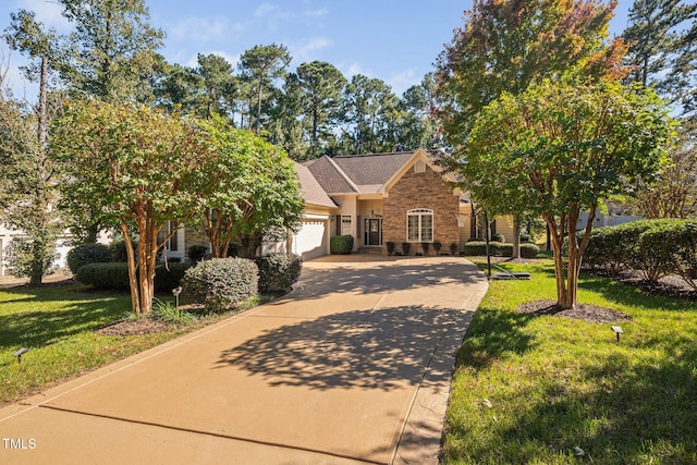 39 Forked Pine Ct, Chapel Hill, NC 27517 - view of property hidden behind natural elements with a garage, driveway, a front lawn, and brick siding