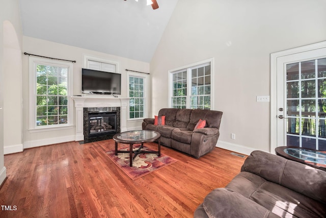 39 Forked Pine Ct, Chapel Hill, NC 27517 - living room with high vaulted ceiling, baseboards, wood finished floors, a fireplace, and a ceiling fan