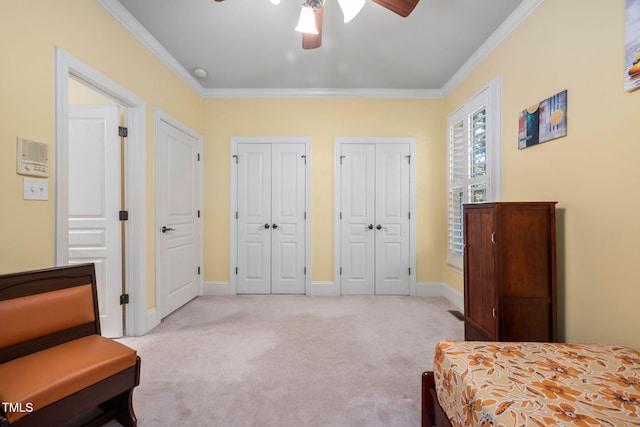 39 Forked Pine Ct, Chapel Hill, NC 27517 - bedroom with light carpet, multiple closets, ornamental molding, baseboards, and a ceiling fan