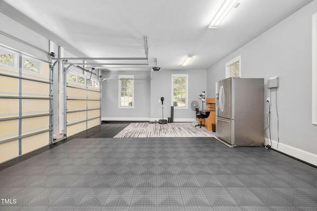39 Forked Pine Ct, Chapel Hill, NC 27517 - garage with stainless steel fridge with ice dispenser, baseboards, and a garage door opener