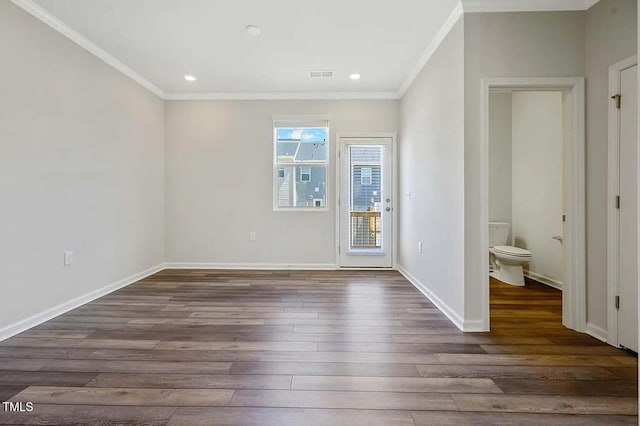 spare room featuring crown molding, hardwood / wood-style flooring, baseboards, and recessed lighting