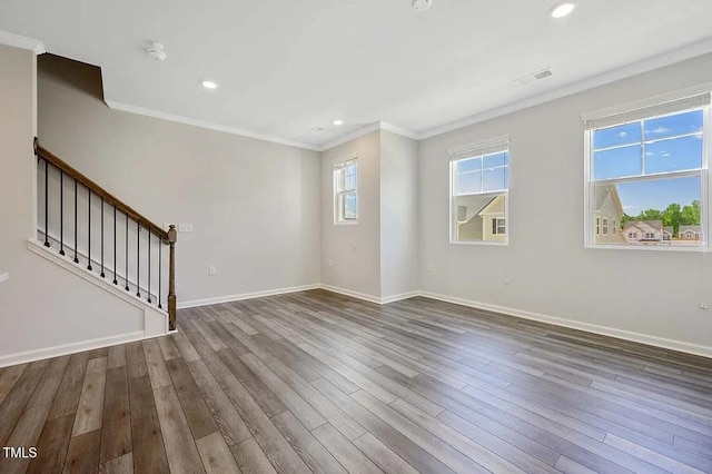 unfurnished room featuring ornamental molding, wood finished floors, baseboards, stairs, and recessed lighting
