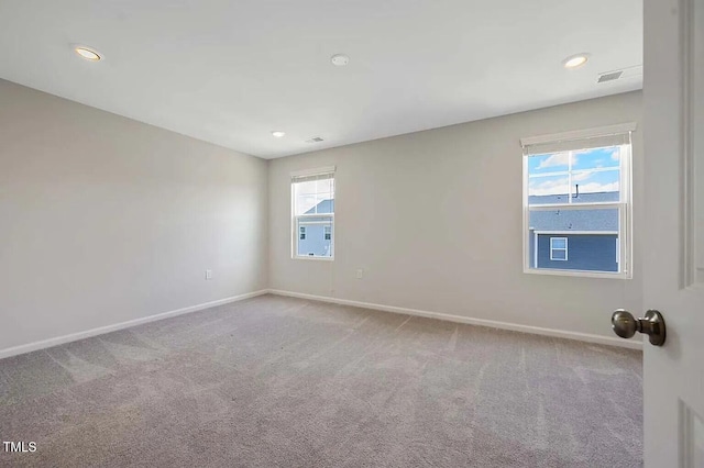 spare room featuring baseboards, carpet flooring, and recessed lighting