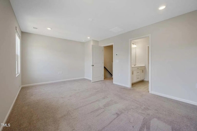 unfurnished bedroom featuring baseboards, light colored carpet, and recessed lighting