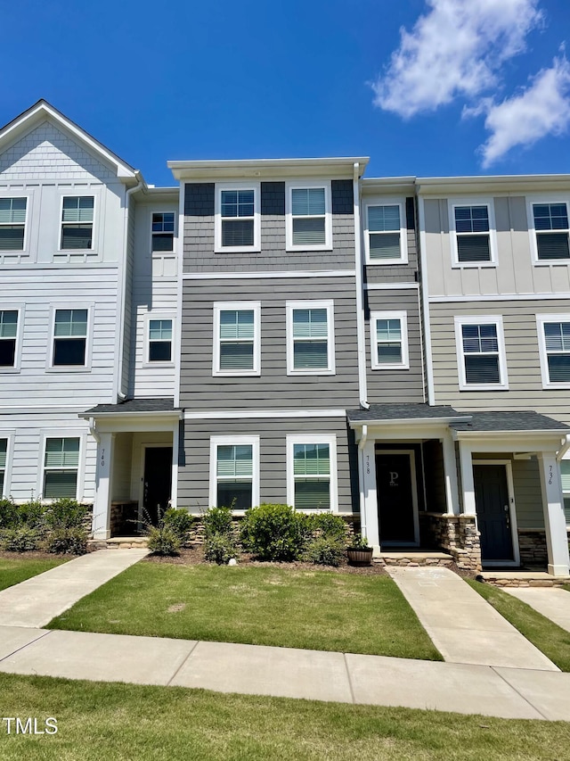 view of property featuring a front lawn