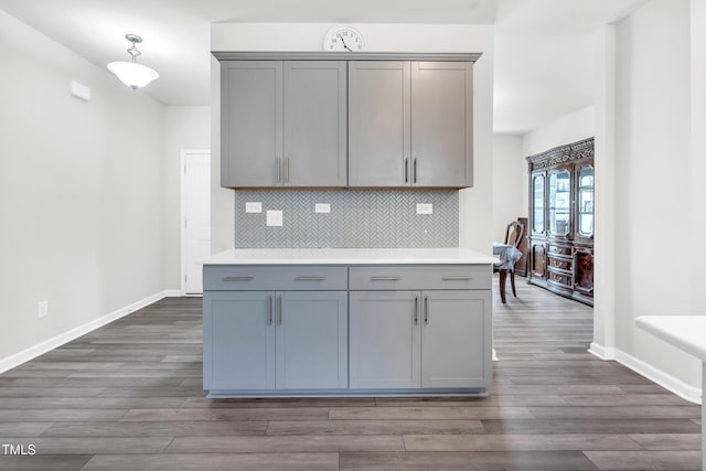 4601 Okeechobee Ct, Fuquay Varina, NC 27526 - kitchen featuring gray cabinetry, dark wood finished floors, backsplash, and light countertops