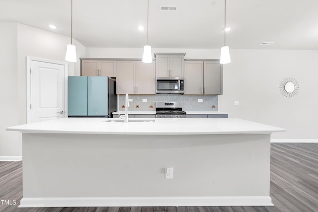 4601 Okeechobee Ct, Fuquay Varina, NC 27526 - kitchen with stainless steel appliances, a sink, a large island, baseboards, and gray cabinetry