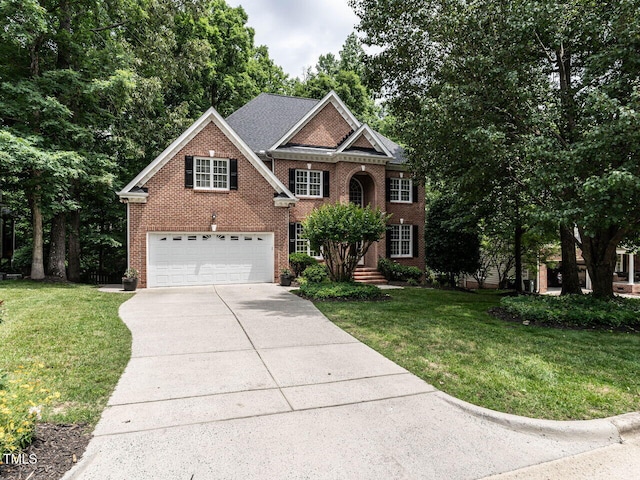 203 Chilcott Ln, Apex, NC 27502 - view of front of home with brick siding, concrete driveway, a garage, and a front lawn