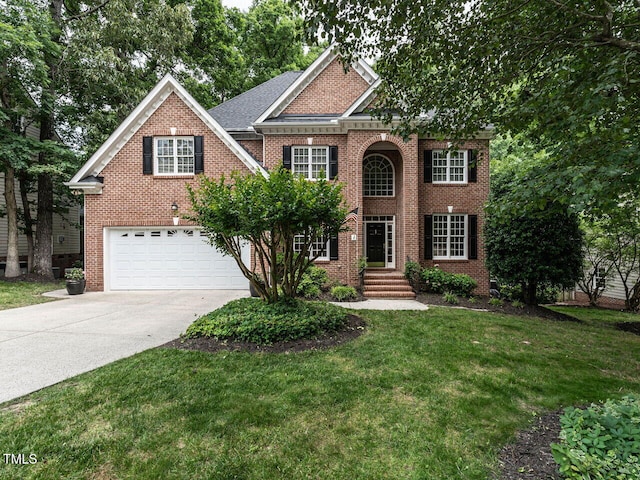 203 Chilcott Ln, Apex, NC 27502 - view of front of house with driveway, an attached garage, brick siding, and a front yard