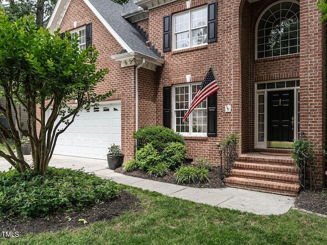 203 Chilcott Ln, Apex, NC 27502 - traditional home with brick siding, roof with shingles, driveway, a garage, and entry steps