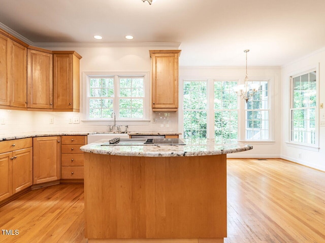 203 Chilcott Ln, Apex, NC 27502 - kitchen featuring a sink, ornamental molding, light wood finished floors, a chandelier, and tasteful backsplash
