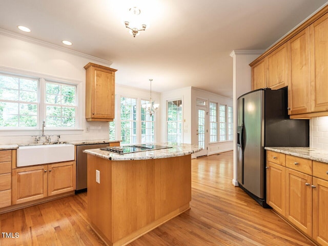 203 Chilcott Ln, Apex, NC 27502 - kitchen with stainless steel appliances, a sink, crown molding, backsplash, and light wood-style flooring