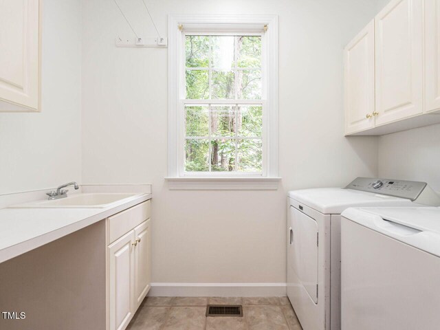 203 Chilcott Ln, Apex, NC 27502 - washroom featuring cabinet space, washer and dryer, and baseboards