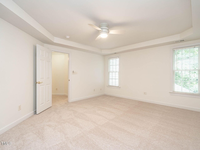 203 Chilcott Ln, Apex, NC 27502 - unfurnished room featuring a raised ceiling, a ceiling fan, light carpet, and baseboards