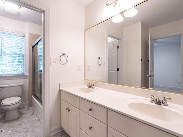 203 Chilcott Ln, Apex, NC 27502 - full bathroom featuring marble look tiles, double vanity, toilet, baseboards, and enclosed tub / shower combo