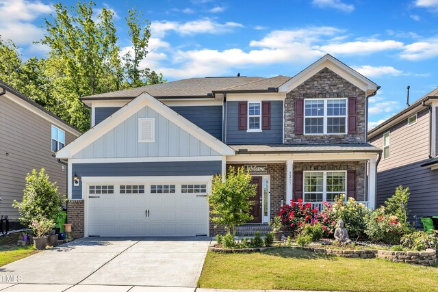 craftsman-style home featuring concrete driveway, a porch, a front lawn, an attached garage, and roof with shingles