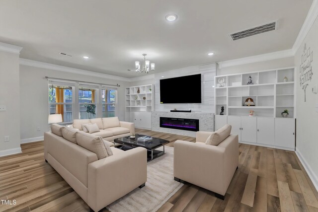 living room featuring ornamental molding, baseboards, a chandelier, wood finished floors, and recessed lighting