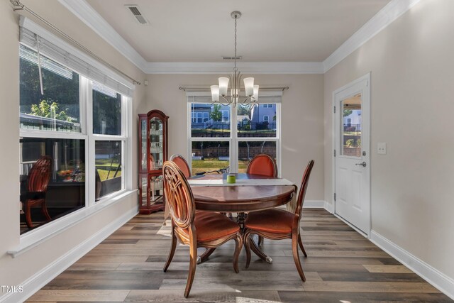 dining room featuring a chandelier, dark wood-style flooring, ornamental molding, and baseboards