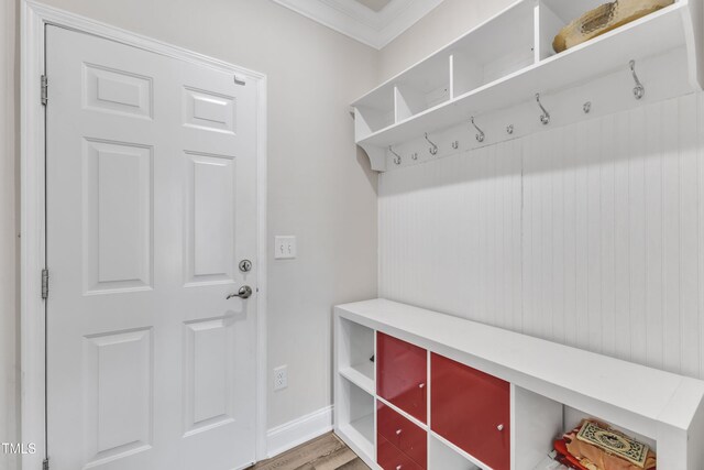 mudroom featuring ornamental molding, wood finished floors, and baseboards