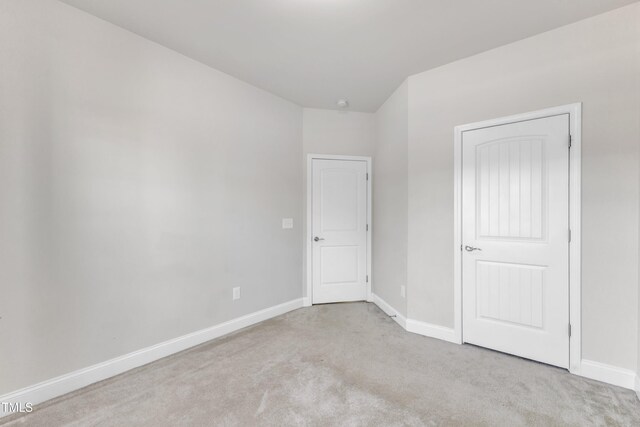unfurnished bedroom with carpet and baseboards