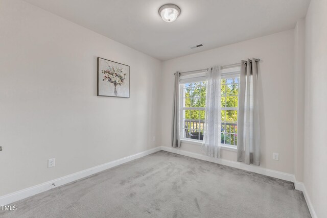 unfurnished room featuring carpet flooring and baseboards