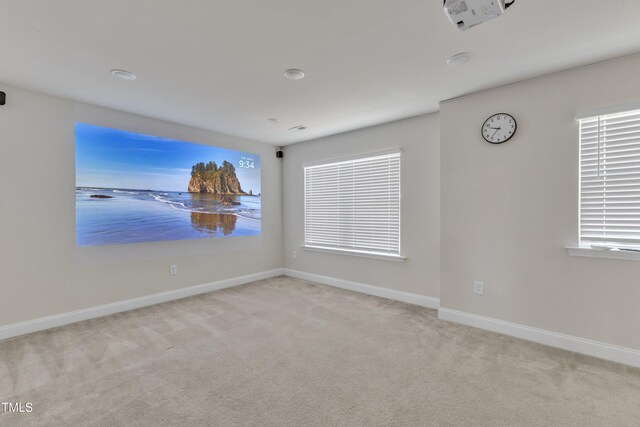 spare room featuring carpet flooring and baseboards