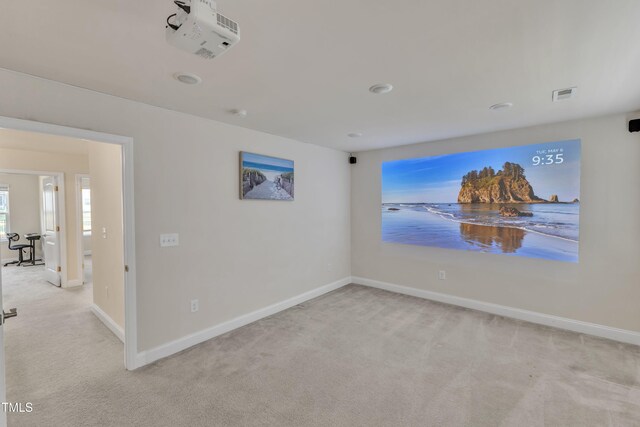 carpeted spare room featuring baseboards