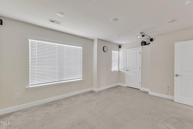 unfurnished room featuring carpet flooring and baseboards