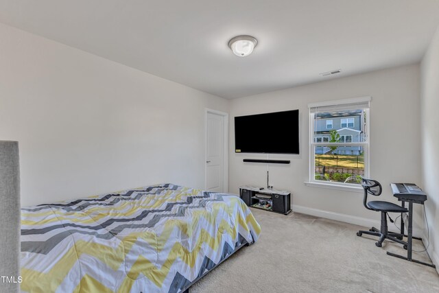 carpeted bedroom featuring baseboards