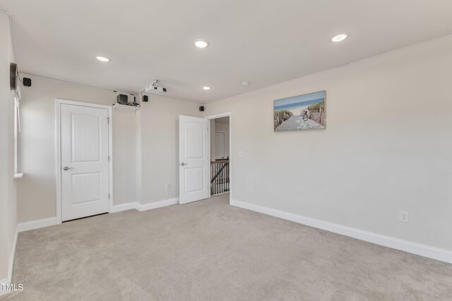 unfurnished bedroom featuring carpet, recessed lighting, and baseboards