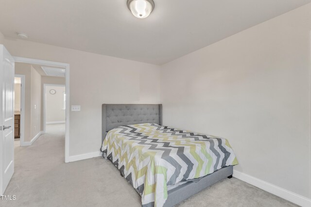 bedroom featuring light carpet and baseboards
