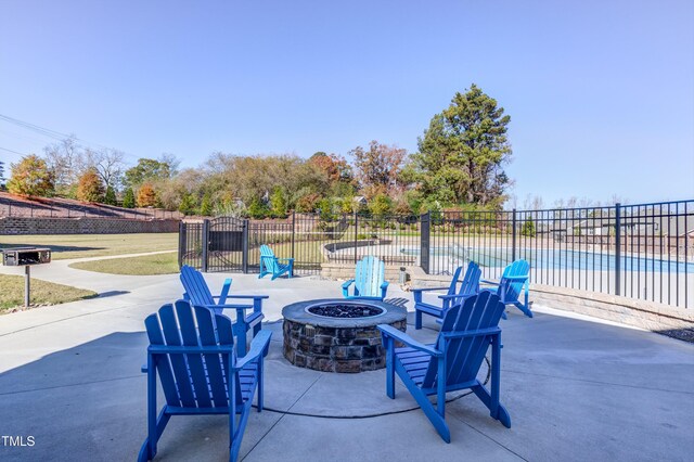 view of patio featuring an outdoor fire pit and fence