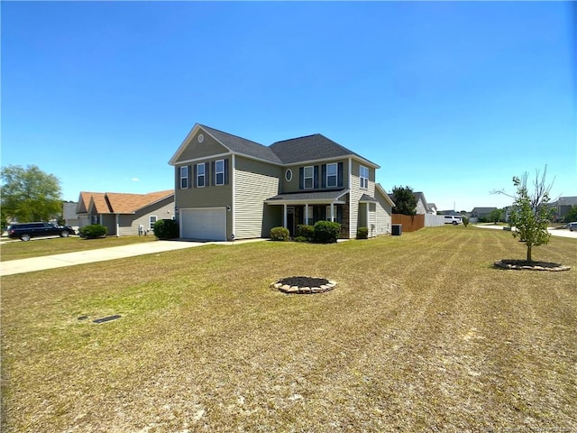traditional-style home with a garage, driveway, and a front yard