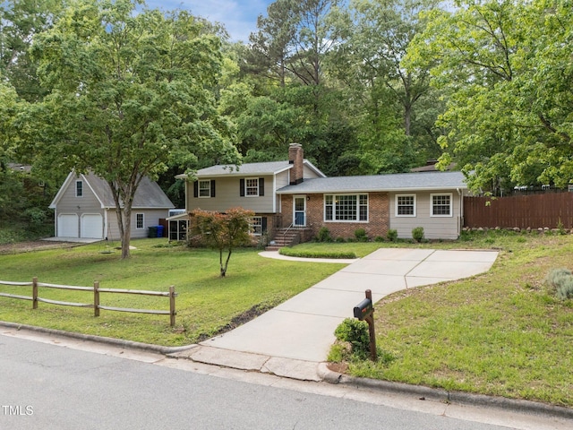 tri-level home with a chimney, brick siding, a garage, and concrete driveway