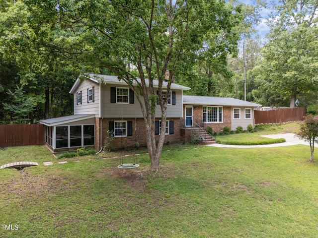 tri-level home with brick siding, a sunroom, and a chimney