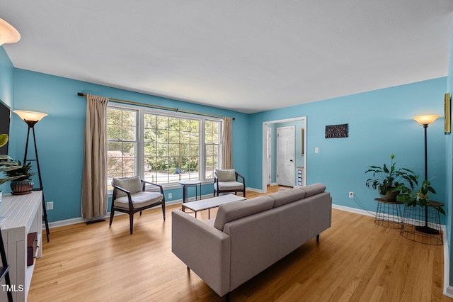 living room with light wood-style floors and baseboards