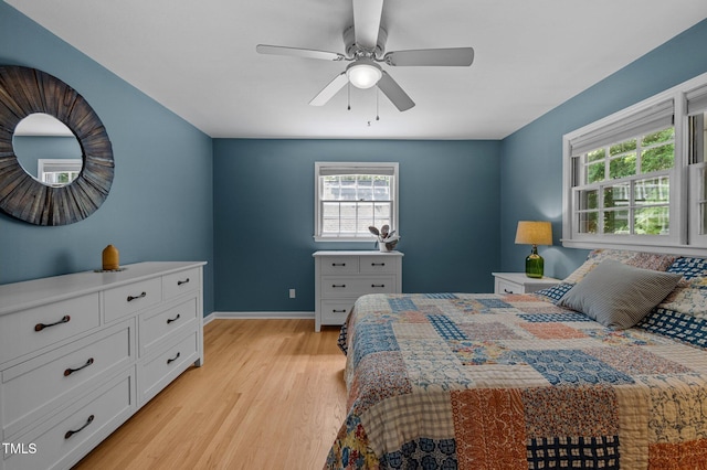 bedroom featuring light wood-style flooring, baseboards, and ceiling fan