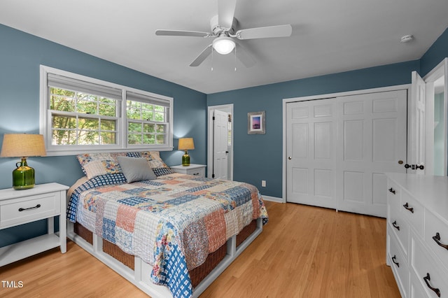bedroom featuring light wood-style floors, a closet, a ceiling fan, and baseboards